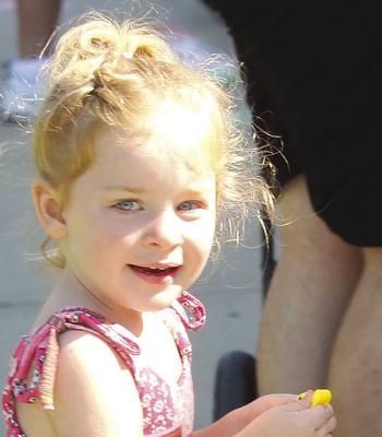 JOELLA BURNS enjoys watching the floats roll down Thompson Avenue during the Waterfest Parade. MIRANDA JAMISON | Staff
