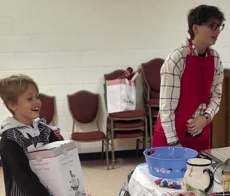 JAXSON PERRY (left) picks out the perfect gift for his caregiver with the help of Aniston Kennedy. See story on page 6. SHARON DONAT | Staff
