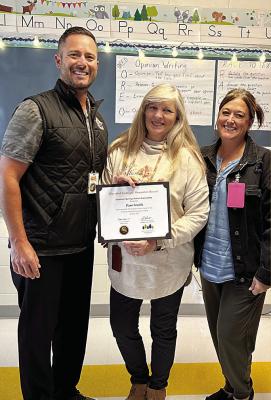 PAM SMITH, PARAPROFESSIONAL at Elkhorn Elementary School, is recognized by the Excelsior Springs School District as the Classified Employee of the Month. Mark Bullimore, director of communications for the district; and Annette Shelton, principal of Elkhorn Elementary School, present the award to Smith. “Elkhorn is so proud of her,” Shelton says. Submitted