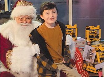 GIBSON WILKINS shares his Christmas wish with Santa during a December toy drive at Three Olives Italian Kitchen and Bakery. MIRANDA JAMISON | Staff