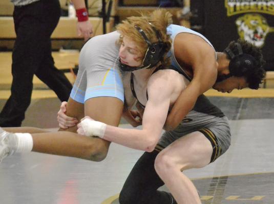 EXCELSIOR SPRINGS SOPHOMORE Cooper Collins lifts Grandview’s Josiah McNeal and prepares for a turn and takedown during the Tigers’ Jan. 17 Greater Kansas City Suburban Conference-Blue Division home dual. DUSTIN DANNER | Staff
