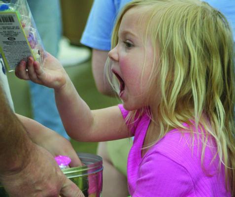 SHARON DONAT | Staff AVERY BROMET finds the “special egg,” filled with $10, large chocolate rabbits, other candy and goodies.