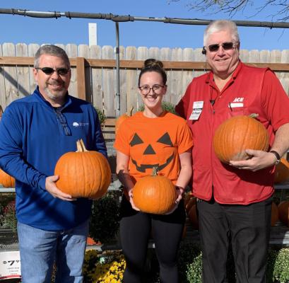 PUMPKINS READY: From left are Tray Harkins with the Gregg Williams Foundation and Flat Branch Home Loans; Cassie Kinnard, Excelsior Springs Community Center aquatics manager; and Bill Westerheide, Westlake ACE Hardware of Excelsior Springs.
