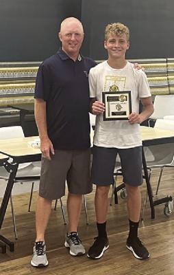 EXCELSIOR SPRINGS tennis coach Richie Marsh (left) presents Austin Collins with the Hustle Award Tuesday night at the high school. DUSTIN DANNER | Staff