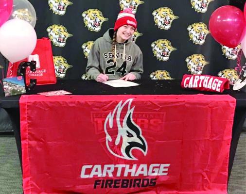 EXCELSIOR SPRINGS senior Alyssa Betts signs her letter of intent to study and compete in women’s wrestling at Carthage College. DUSTIN DANNER | Staff