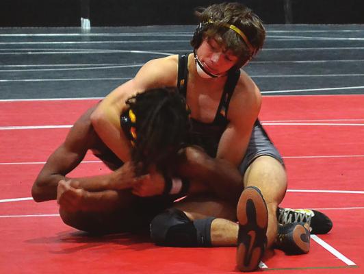DUSTIN DANNER | Staff FRESHMAN RYNE MARCUM sets up his Cameron opponent for a cradle in his first match this season.
