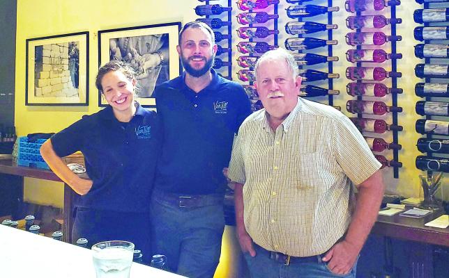 SARAH AND JASON VAN TILL stand with father Cliff Van Till behind the bar of the family’s newest business, Pairings by Van Till, located in a newly-restored downtown building on Thompson Avenue. NICOLE SCOTT | Staff