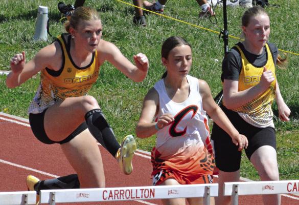 ADDISON CHAPMAN (left) fights for the lead in the girls 100-meter high hurdles at Class 1 District 4 competition. Also shown is Orrick teammate Natalie Cox (right). SHAWN RONEY | Staff
