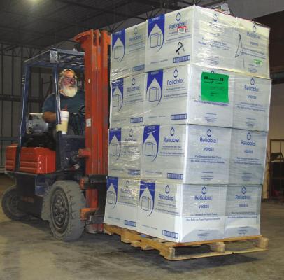 CHURCH OF LIBERTY Pastor Doug Perry drives a forklift while moving a few of the thousands of boxes of paper products into position in the church warehouse in Excelsior Springs. J.C. VENTIMIGLIA | Staff