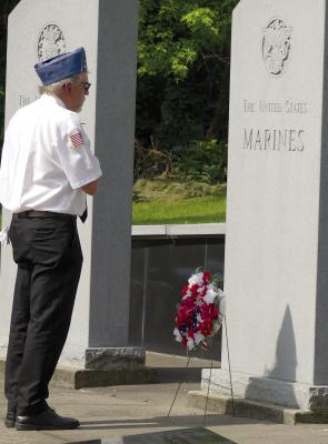 RODNEY HOLT PLACES a wreath and takes a moment of silence for the fallen soldiers who have served the United States Marines. More photos on page 12. ELIZABETH BARNT | Staff