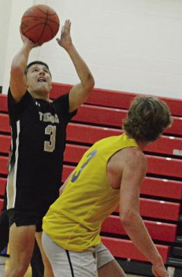 OWEN O’DELL (left) attempts a shot during Excelsior Springs’ summer-league game with Penney of Hamilton. More boys basketball coverage on page 8. SHAWN RONEY | Staff