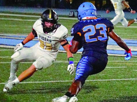 EXCELSIOR SPRINGS senior Zeb McBee (left) measures up Grandview’s Mikhail Williams to make a tackle Sept. 29 at Grandview. For additional coverage of the Greater Kansas City Suburban Conference-Blue Division clash in varsity 11-man football, see page 10. TIM HARLAN | Submitted