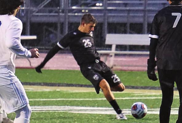 SENIOR ANDREW ARMSTRONG boots the ball toward the goal during Excelsior Springs’ meeting last week with Harrisonville at Tiger Stadium. DUSTIN DANNER | Staff