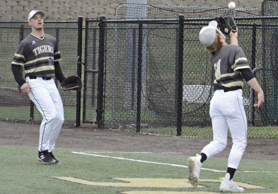 STARTING PITCHER Ryne Marcum catches a foul pop up as first baseman Jacob Bright watches early in Excelsior Springs’ March 22 home tournament meeting with Winneontka. SHAWN RONEY | Staff