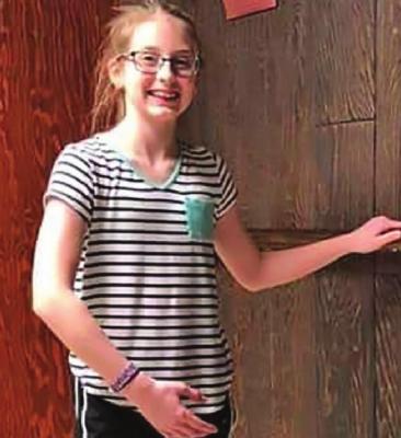 TAYLOR WOODS practices at the dance bar.