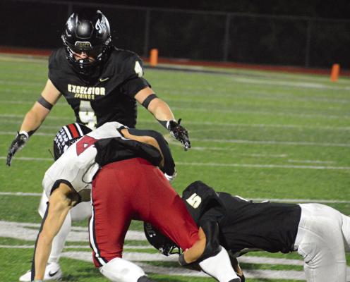EXCELSIOR SPRINGS senior Austin Eason (left) gets ready to assist Lukas Vardy (right) in bringing down Chillicothe running back Henry Hurtgen. SHAWN RONEY | Staff