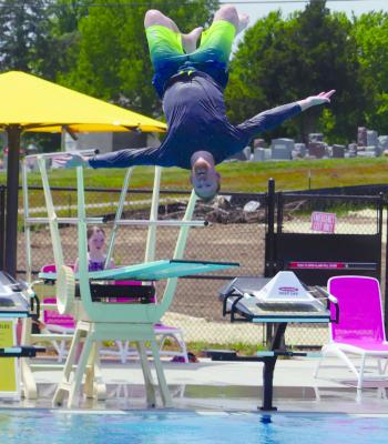 Excited to use the pool for the first time, Greg Broadbent does a flip off the diving board into the deep end of the pool. ELIZABETH BARNT | Staff