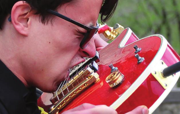WITHOUT missing a note, electric guitar soloist Johnny Garrett shifts to playing with his teeth.