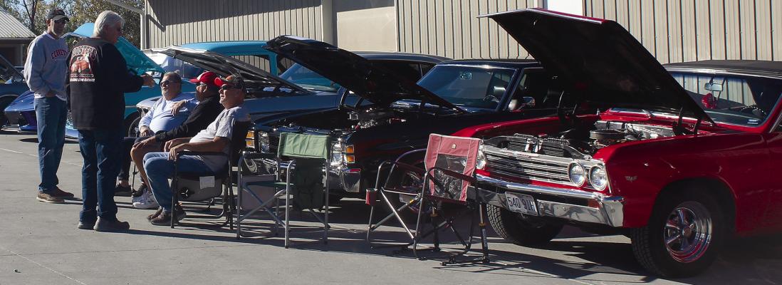 COMMUNITY MEMBERS stop to visit with vehicle owners about their stories with their cars. MIRANDA JAMISON | Staff