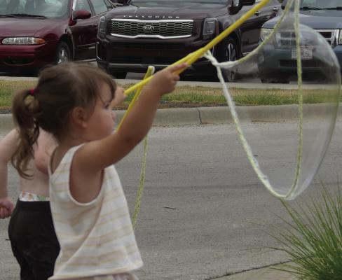 August Gonzalez waves giant bubbles into the air. ELIZABETH BARNT | Staff