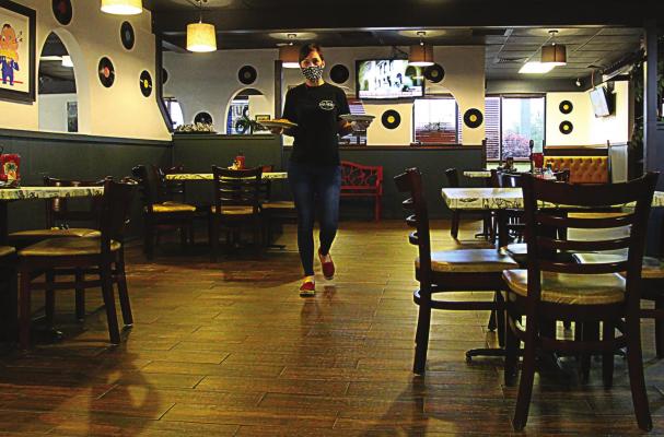 AT MUGGS DINER, 119 Crown Hill Road, Excelsior Springs, Kate McCullom carries a tray of food through the airy dining area to waiting customers. J.C. VENTIMIGLIA | Staff