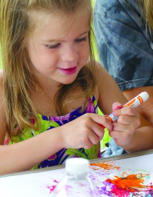 Harlie Kinney uses an array of color for her art project. More photos on page 7. ELIZABETH BARNT | Staff