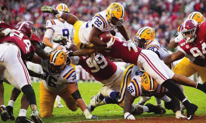 IT TAKES FOREVER for the Kansas City Chiefs to draft Clyde Edwards-Helaire, seen leaping through the University of Alabama defense for LSU. COURTESY OF THE LSU ATHLETICS WEBSITE