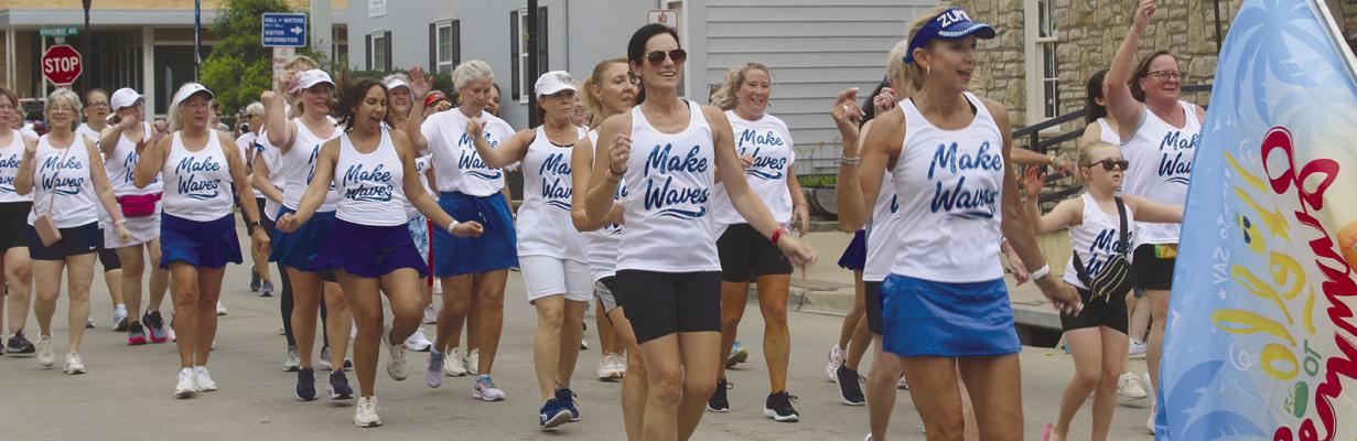 PARTICIPANTS DANCE their way through downtown with a community Zumba workout.