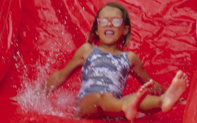 Adeline Daniel makes a splash on the water slide during the Parks and Recreation Month kickoff event. More photos on page 7. ELIZABETH BARNT | Staff