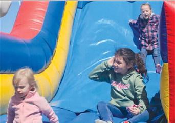 CHILDREN MAKE their way down an inflatable slide as Easter festivities continue.