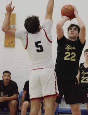 DRAKE SIMONITIS (right) attempts a jump shot for Excelsior Springs as Odessa’s Cole Westerhold contests it during the Husker Classic. Additional boys and girls tournament photos on page 8. SHAWN RONEY | Staff