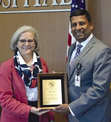 AMERICAN HOSPITAL ASSOCIATION Regional Executive Liz Sumy (left) presents Liberty Hospital President and CEO Raghu Adiga with an award of recognition for the hospital’s participation and leadership within the organization. Submitted