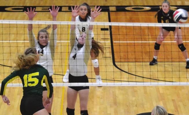 SOPHOMORE ROWYN PEKAREK and senior Isabelle Jones-Yuille team up for a double-block against Maryville that sends the ball flying to the side of the court. DUSTIN DANNER | Staff