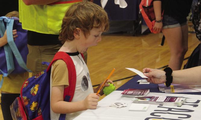 MIRANDA JAMISON | Staff DAWSON SPEAR’S eyes light up with excitement as he discovers the array of fascinating toys awaiting him at the resource fair, eagerly anticipating the treasures he will bring home.