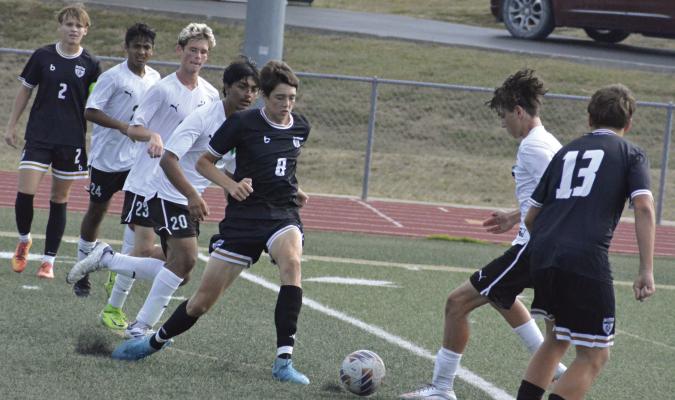 TYLER WARTNER (center), shown challenging for a ball in 2025, is part of the nucleus of returning players for Excelsior Springs in varsity boys soccer. SHAWN RONEY | Staff