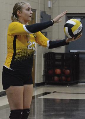 EMERIE QUALLS prepares to serve in Orrick’s season-opening match against Lone Jack. SHAWN RONEY | Staff