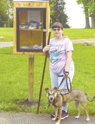 SOPHIA STEPHENSON stands next to her newly finished “Little Free Pet Pantry” with Marvin. TARA ALTIS | Staff