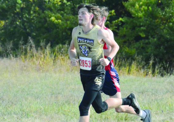 GAVIN WILMES runs for the Tigers Oct. 4 at their home cross country meet. SHAWN RONEY | Staff