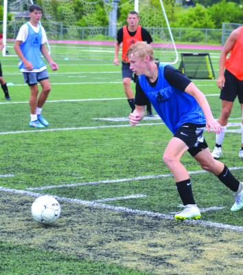 EXCELSIOR SPRINGS coach Zac Ganzer expects his Tigers, seen here practicing recently on the Tiger Stadium pitch, to possess the ball more this season and look to break down opponents as they eye a return to state.