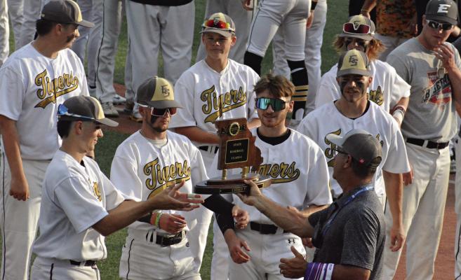 MEMBERS OF THE Excelsior Springs baseball team receive the Class 4 third-place trophy June 1 at Sky Bacon Stadium. Tigers pictured are (front row, from left) Mason Danner, Colson Moore, Brendan Blackburn, Broc Dusek; (back row) Brayden Lewis, Klayton Glaspy, Cooper Collins and Simon Holst, assistant coach. Additional baseball coverage on pages 6-7. SHAWN RONEY | Staff