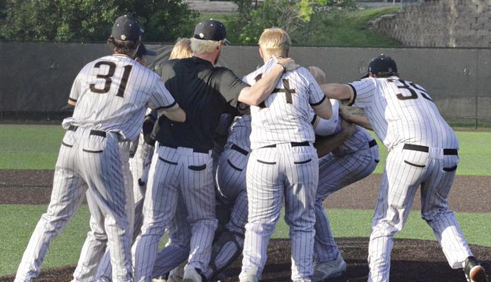 THE TIGERS storm the mound for a celebratory dogpile May 16 after defeating Oak Grove for the Class 4 District 13 baseball title at Excelsior Springs. SHAWN RONEY | Staff