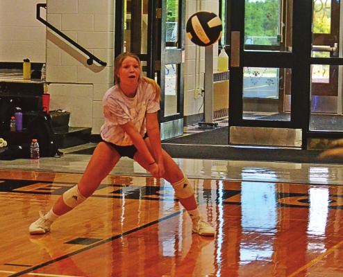 SENIOR KYLI CROWLEY works on passing drills with Excelsior Springs varsity coach Kathryn Beile. DUSTIN DANNER | Staff