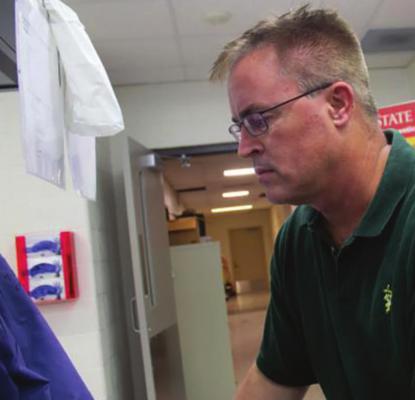 AT THE IOWA State University Veterinary Diagnostic Lab, Phil Gauger uses DNA analysis tools to diagnose porcine epidemic diarrhea virus. Now, the same equipment and expertise is being used in COVID-19 testing.