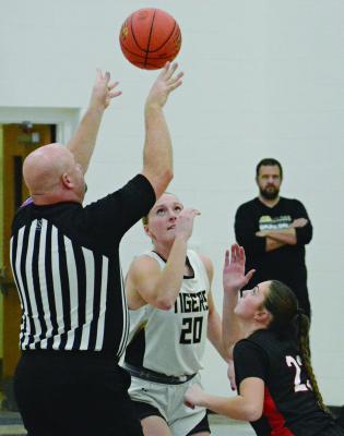 THE CENTER OFFICIAL tosses the ball into the air as Excelsior Springs’ Kinley Rogers (center) and Richmond’s Emma Hash get ready for the tipoff. SHAWN RONEY | Staff