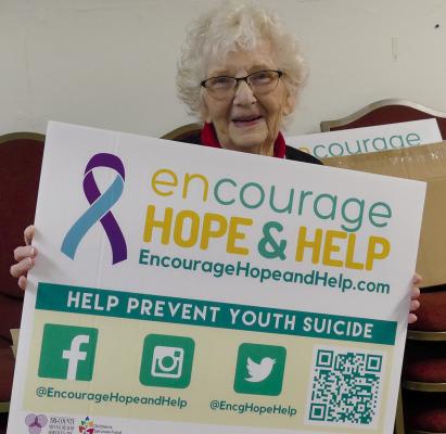 NAZARENE CHURCH member Shirley Knipker holds a sign to show support for people in need. She attended the community “Warm Inside and Out” soup lunch and clothing drive event held at the Excelsior Springs Good Samaritan Center.