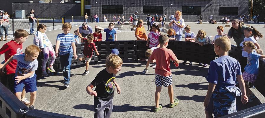 LEWIS ELEMENTARY students dive into a lively game of gaga ball during outdoor festivities.