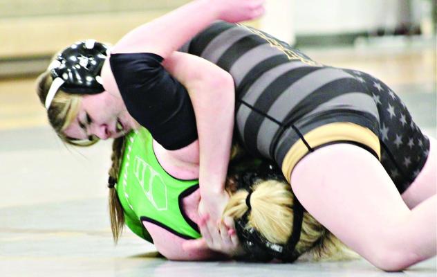 EXCELSIOR SPRINGS sophomore Lauren Park, top, secures a half nelson and puts Smithville’s Jenna Holmes to the mat to help the Tigers edge the Warriors in a 39-36 Jan. 4 dual at Excelsior Springs High School. DUSTIN DANNER | Staff