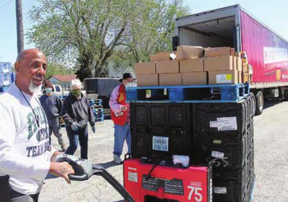 A DRIVER for the Harvesters Community Food Network in Kansas City, Frank Gray, unloads food from the trailer onto the lot of the Salvation Army Family Store in Richmond. ‘ J.C. VENTIMIGLIA | Staff