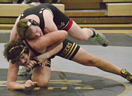 JUNIOR ANTHONY CIRCO (bottom position) works to get free from Marshall’s Tyler Brooks during Jan. 25 dual action at Excelsior Springs. DUSTIN DANNER | Staff