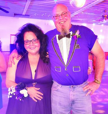 EAGLES CLUB members Kris and Ryan Newell celebrate back to school week in a different fashion, a retro-themed prom dressing up for the years they graduated and raising funds for local charities. NICOLE SCOTT | Staff